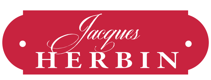 Jacques Herbin-Logo in Form eines Pariser Straßenschildes. Rot mit weißem Schriftzug.