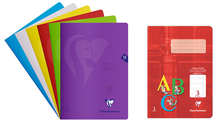 Bild von sechs bunten Schulheften, jedes in Blau, Grau, Gelb, Rot, Grün und Lila, fächerförmig ausgebreitet. Daneben liegt ein rotes Schulheft für die Grundschule mit „ABC“ in großen Buchstaben und einem kleinen linierten Rechteck zum Schreiben eines Namens. Die Hefte sind von Clairefontaine.