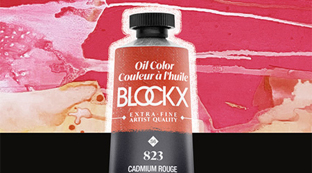 Tube mit roter Ölfarbe von Blockx. Der obere Teil mit Verschluss ist sichtbar. Im Hintergrund unten ein schwarzer Balken und oben rot-goldenes, verwischtes Muster.